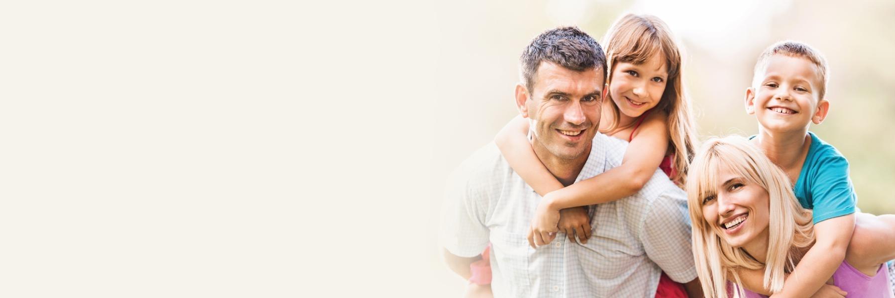 Family smiling & hugging l Emergency Dentistry St. Cloud FL