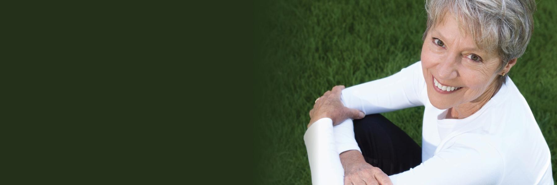 Woman in the grass | Porcelain Veneers St Cloud FL