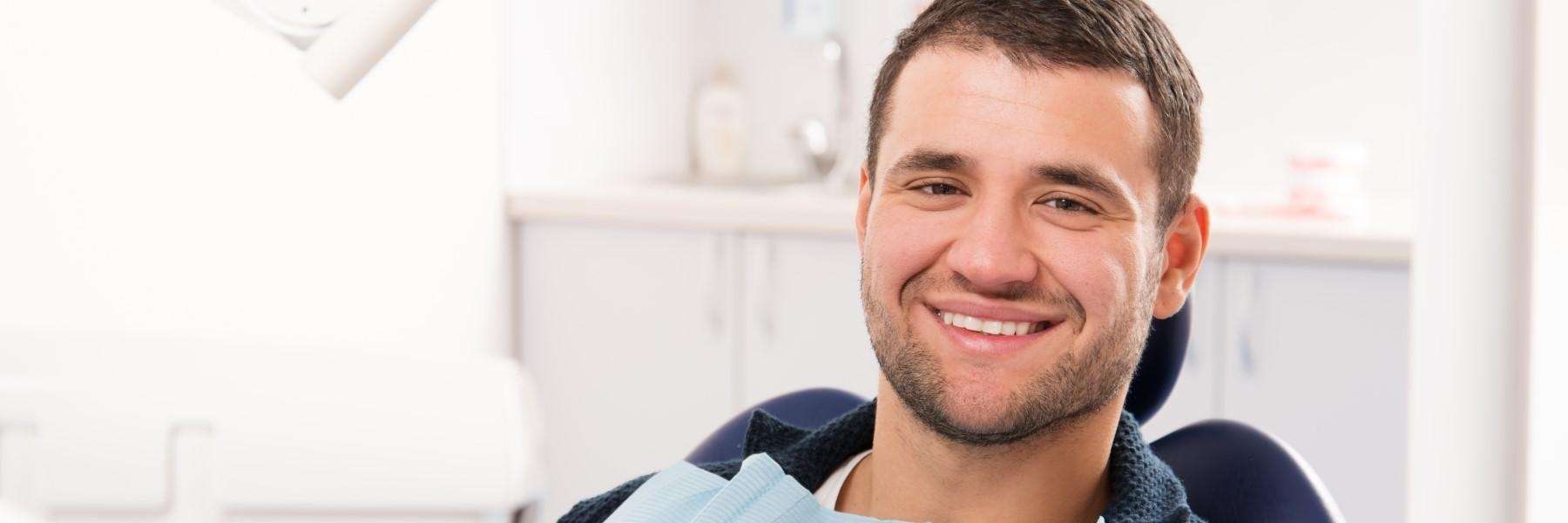 man smiling confidently with his new cleaned teeth in St Cloud FL