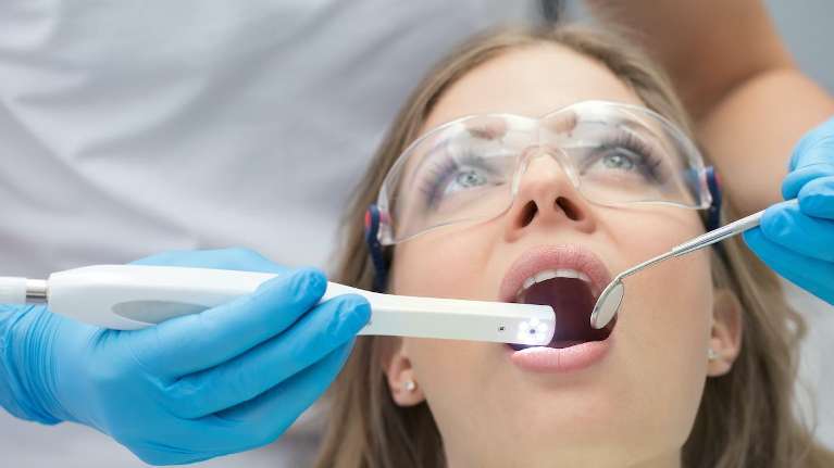 Dentist checking implant of woman patient in St. Cloud FL