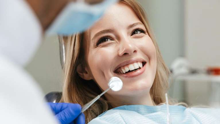 woman having teeth cleaning in St Cloud FL