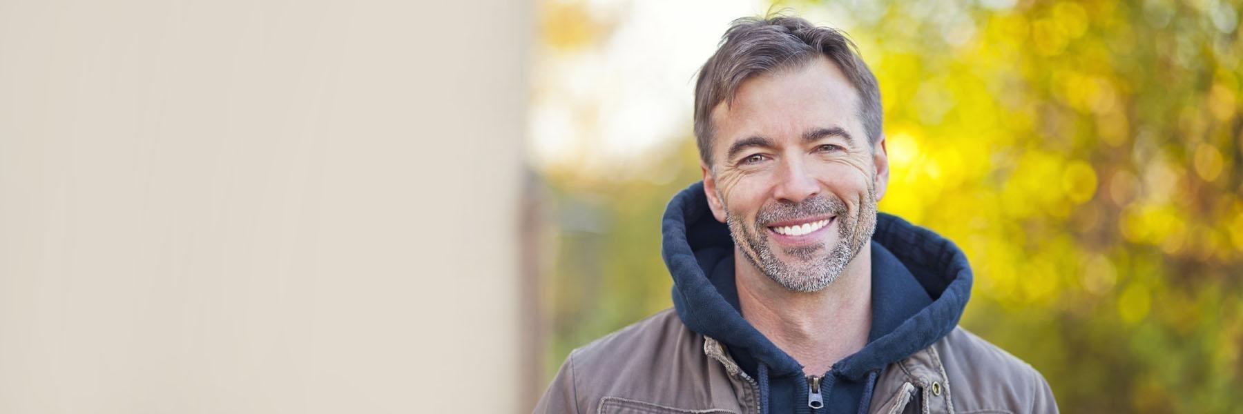 Adult man wearing porcelain veneers in St. Cloud