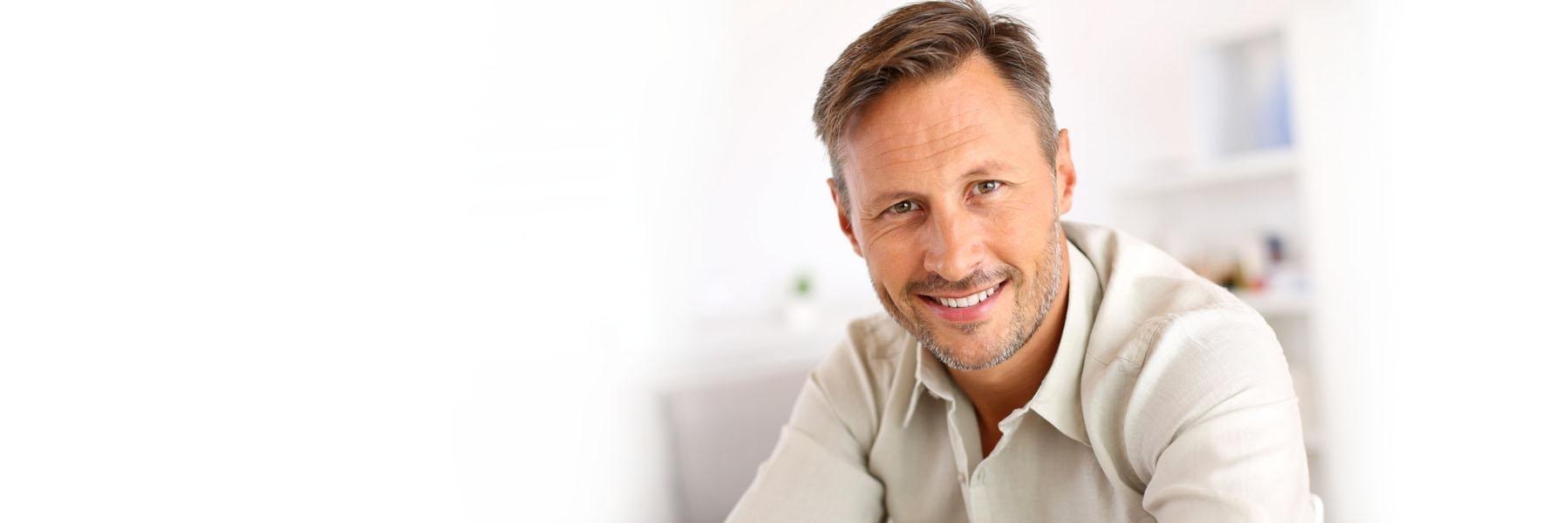 Older man with facial hair smiling l Root canals St. Cloud Florida
